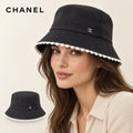 CHANEL bucket hat worn by a female model, with product detail inset.