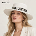 Prada hat worn by a female model, showing the hat shape and detailing.