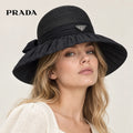 Prada hat worn by a female model, showing the hat shape and detailing.