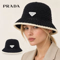 PRADA bucket hat worn by a female model, with product detail inset.