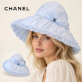 CHANEL wide-brim hat worn by a female model, with product detail inset.