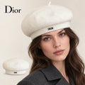 Dior beret worn by a female model, with product detail inset.