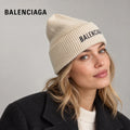 Balenciaga ribbed knit beanie worn by an adult female model