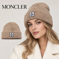 Moncler beanie worn by an adult female model, with product detail inset.