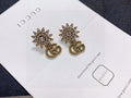 Gucci Gold-Tone Sunburst and GG Drop Earrings - album image 1