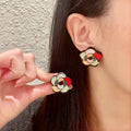 Chanel Interlocking C Camellia Stud Earrings - album image 1