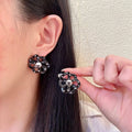 Chanel Interlocking C Camellia Openwork Stud Earrings - album image 1