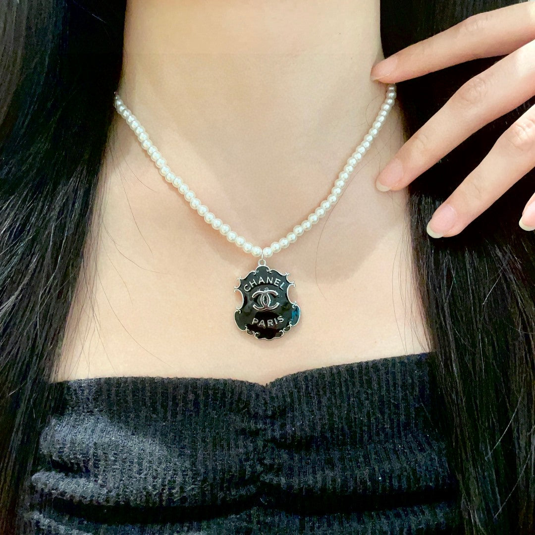 Chanel Interlocking C Pearl Letter Necklace - album image 1