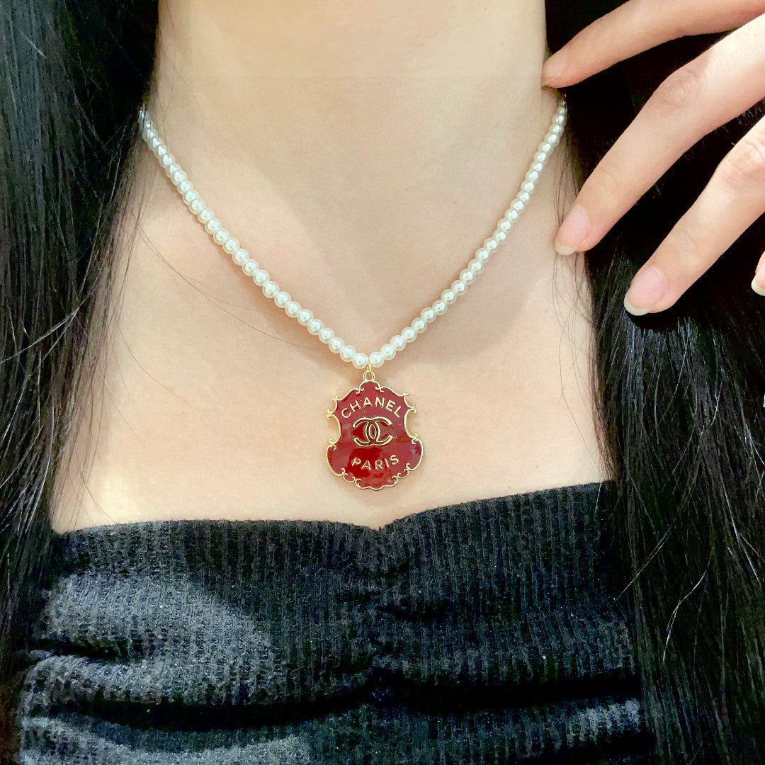 Chanel Interlocking C Pearl Letter Necklace - album image 1