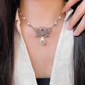 Chanel Interlocking C Bow Butterfly Pearl Crystal Accent Necklace - album image 1