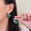 Chanel Interlocking C Pearl Asymmetric Earrings - album image 1