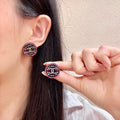 Chanel Interlocking C Stud Earrings - album image 1