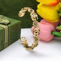 Gucci Interlocking G Antique Gold-Tone Sunflower Bangle - album image 1
