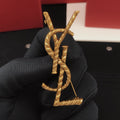 Saint Laurent Antique Gold-Tone Rope-Textured Monogram Brooch - album image 1