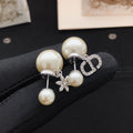 Dior Silver-Tone Asymmetric Star CD Earrings - product image 1