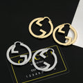 Gucci GG Circular Hoop Earrings in Gold and Silver Tones - album image 1
