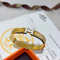 Hermès White Leather Gold-Tone H Bracelet - album image 1