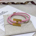 Hermès Pink Braided Gold-Tone H Bracelet - album image 1