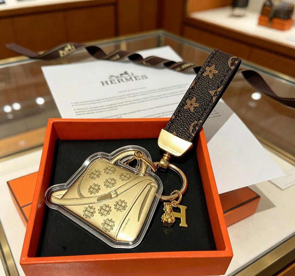 Hermès Gold-Tone Handbag-Charm Keychain with Black Strap - album image 3
