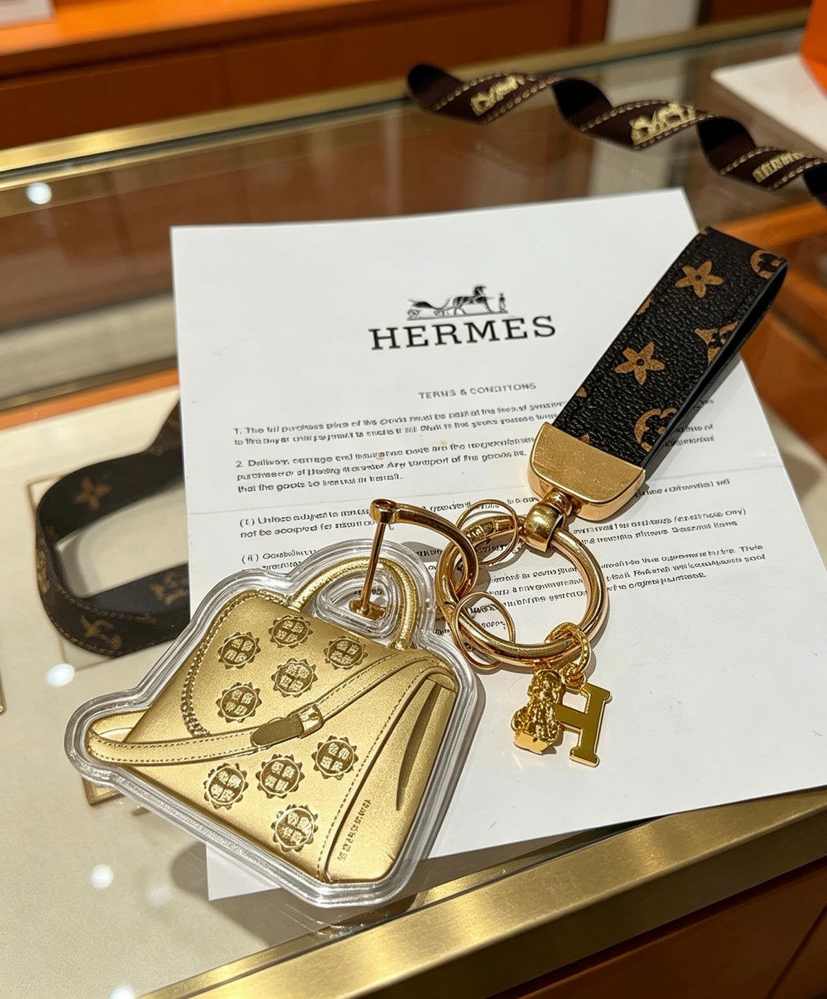 Hermès Gold-Tone Handbag-Charm Keychain with Black Strap - album image 6