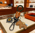 Hermès Tan Horse Keychain with Black Braided Cord - album image 1