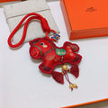 Hermès Red Flower-Charm Keychain with Red Braided Cord - album image 1