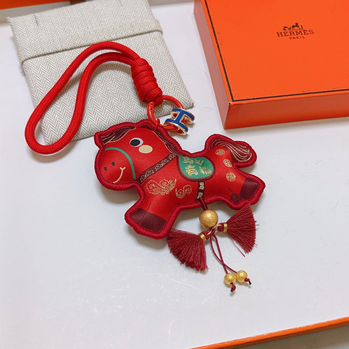 Hermès Red Flower-Charm Keychain with Red Braided Cord - album image 1