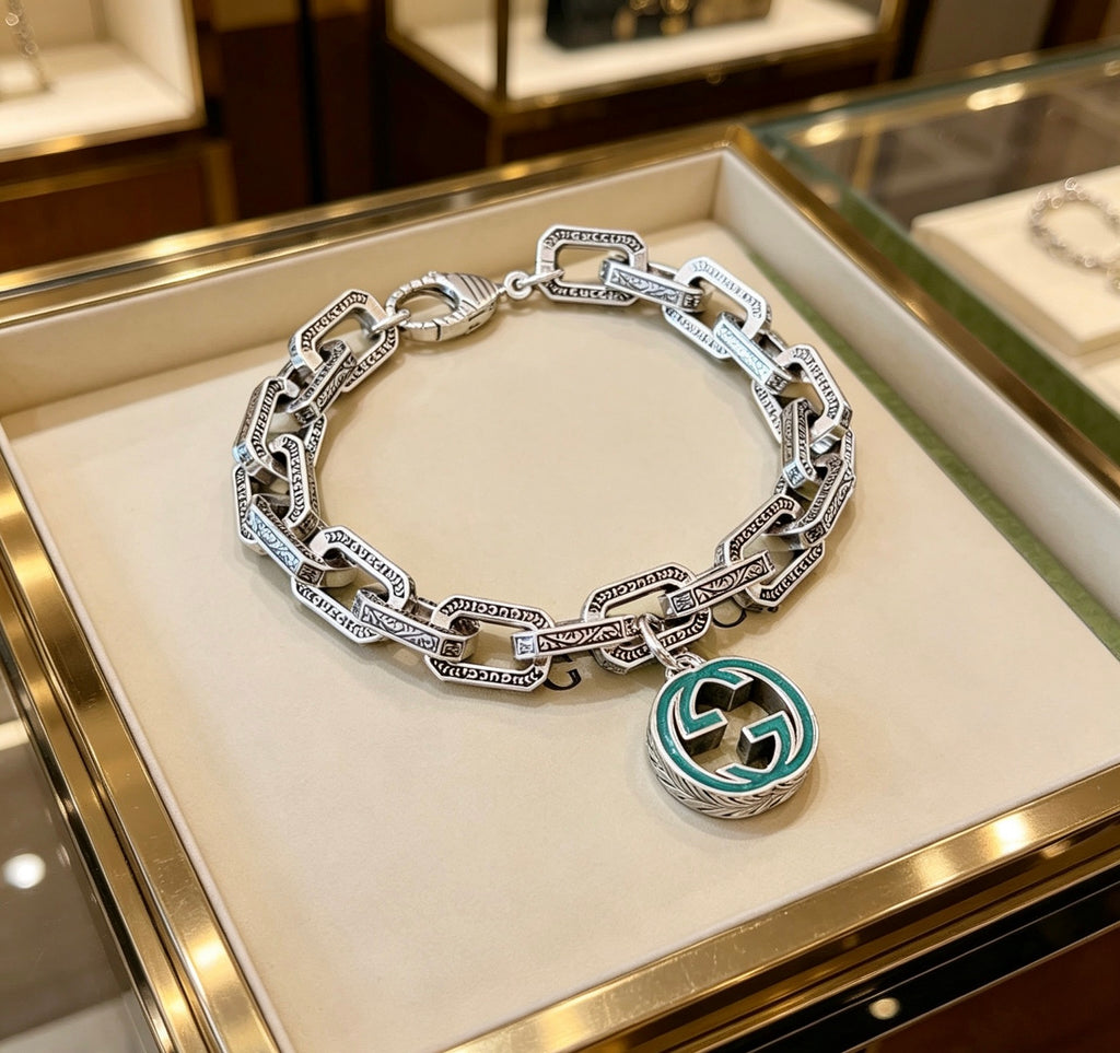 Gucci Silver-Tone Oval Link Bracelet with Blue Circular Charm - album image 1