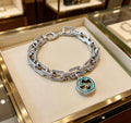 Gucci Silver-Tone Oval Link Bracelet with Blue Circular Charm - album image 1