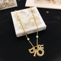 Dior Asymmetric Bow and Round Pendant Necklace - product image 1