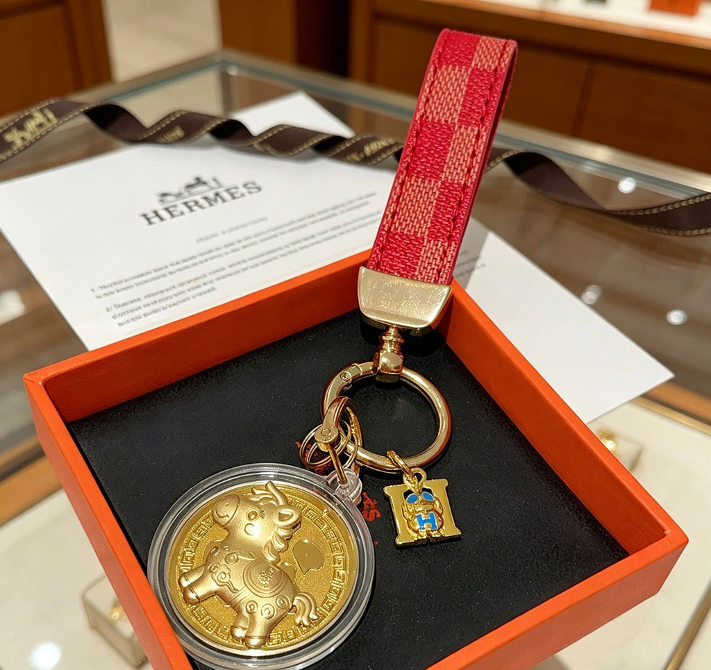 Hermès Gold-Tone H Medallion Keychain with Brown Strap - album image 1