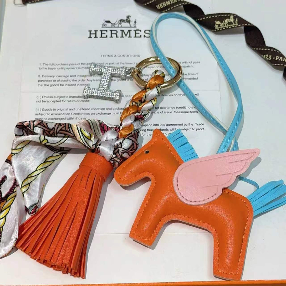 Hermès Orange Horse Bag Charm with Blue Cord and Tassel - album image 1