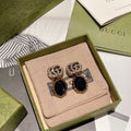 Gucci Interlocking G Antique Gold-Tone White Black GG Letter Earrings - album image 1