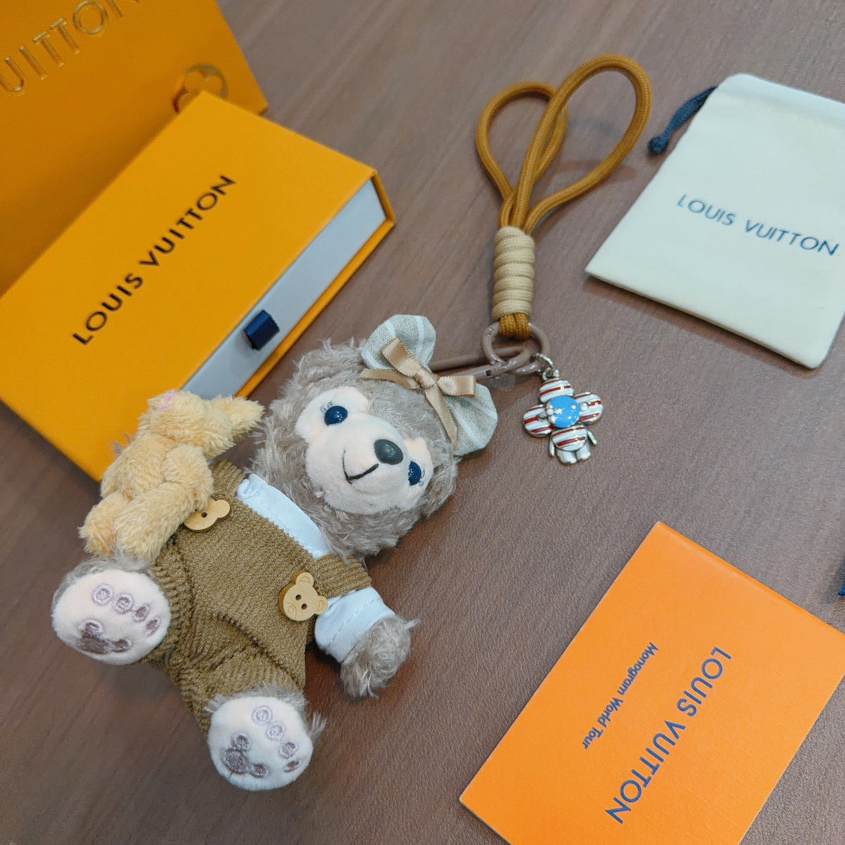 Louis Vuitton Gray Plush Character Keychain in Tan Outfit - album image 4