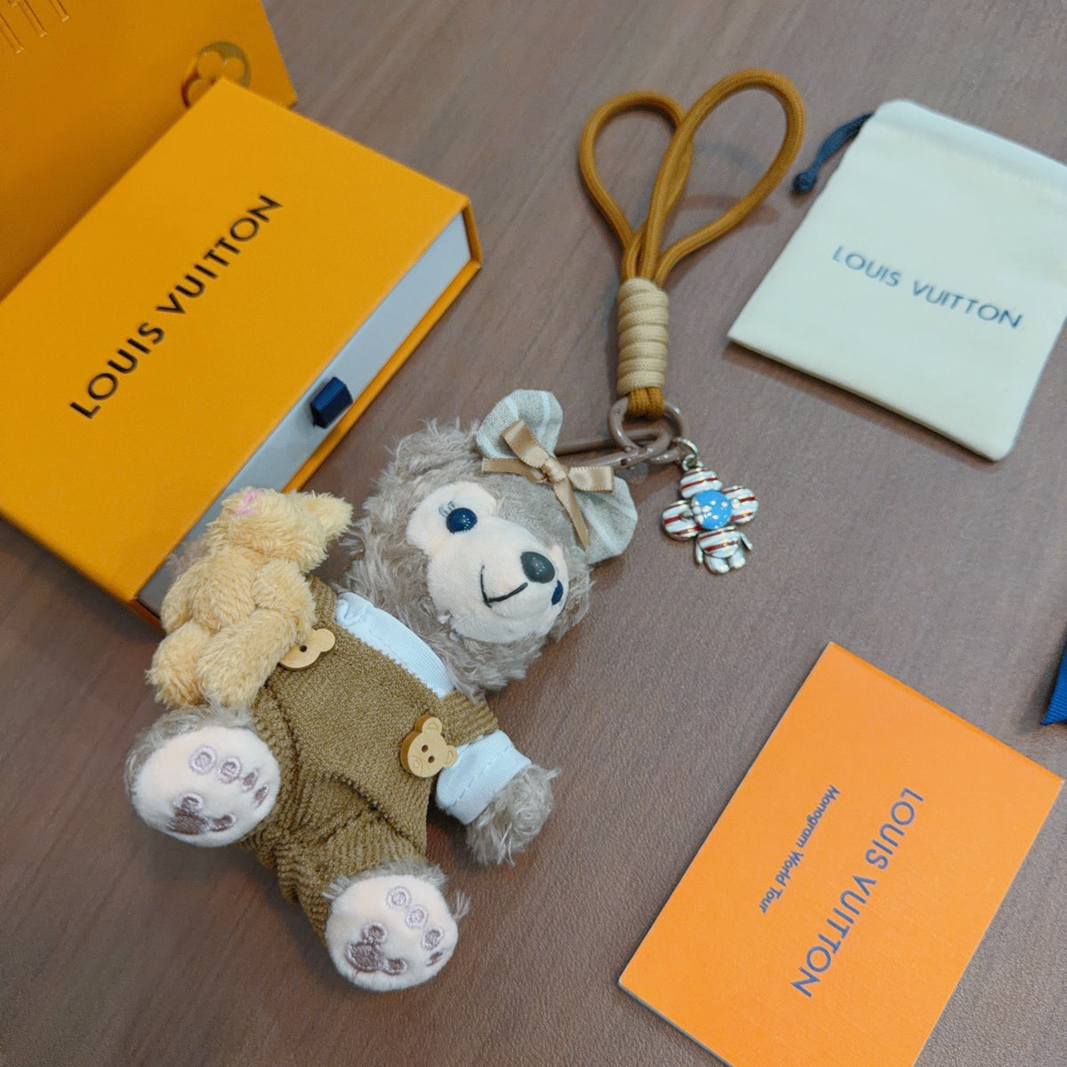 Louis Vuitton Gray Plush Character Keychain in Tan Outfit - album image 3