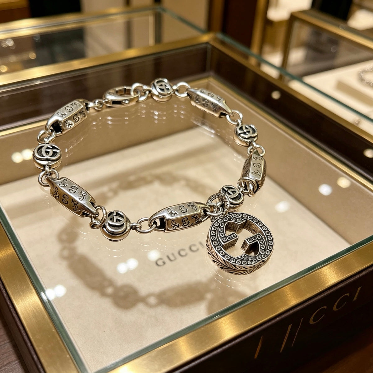 Gucci Silver-Tone Rectangular Link Bracelet with Medallion Charm - album image 1