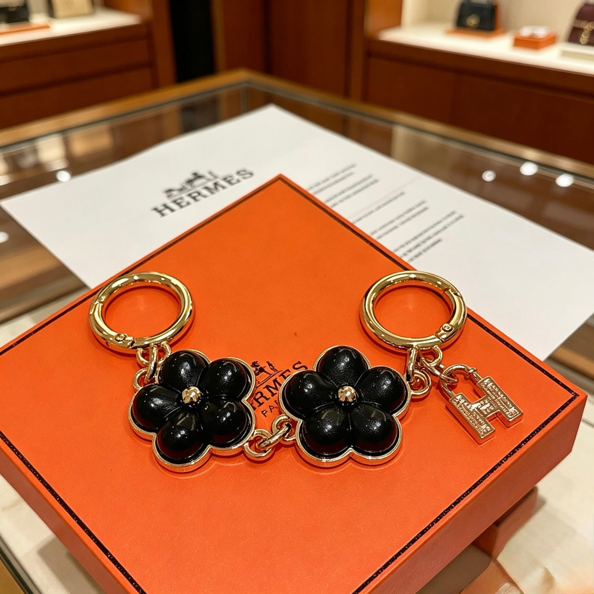 Hermès Black Flower-Charm Keychain - album image 1