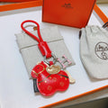 Hermès Red Flower-Charm Keychain with Red Braided Cord - album image 1