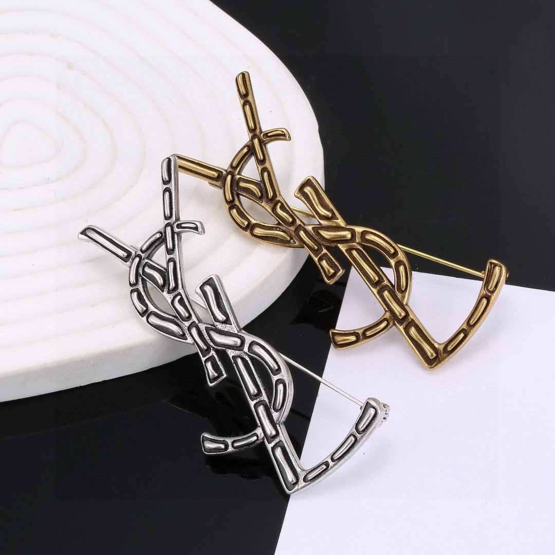 Saint Laurent Silver and Gold-Tone Twisted Monogram Brooch - album image 1