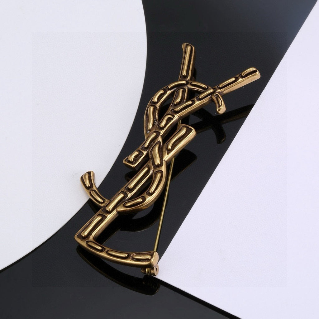 Saint Laurent Silver and Gold-Tone Twisted Monogram Brooch - album image 6
