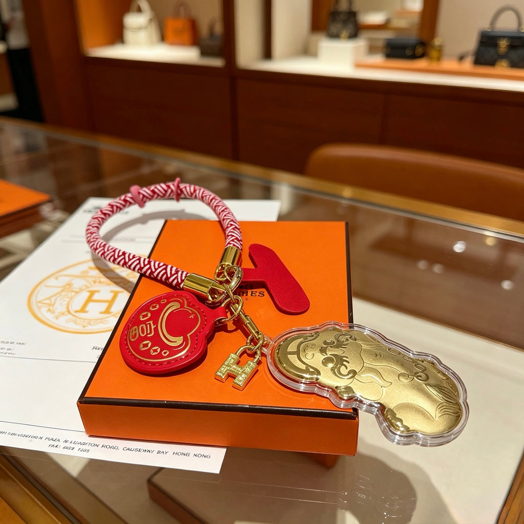 Hermès Gold-Tone Horse and Red H Disc Keychain with Pink Braided Cord - album image 2