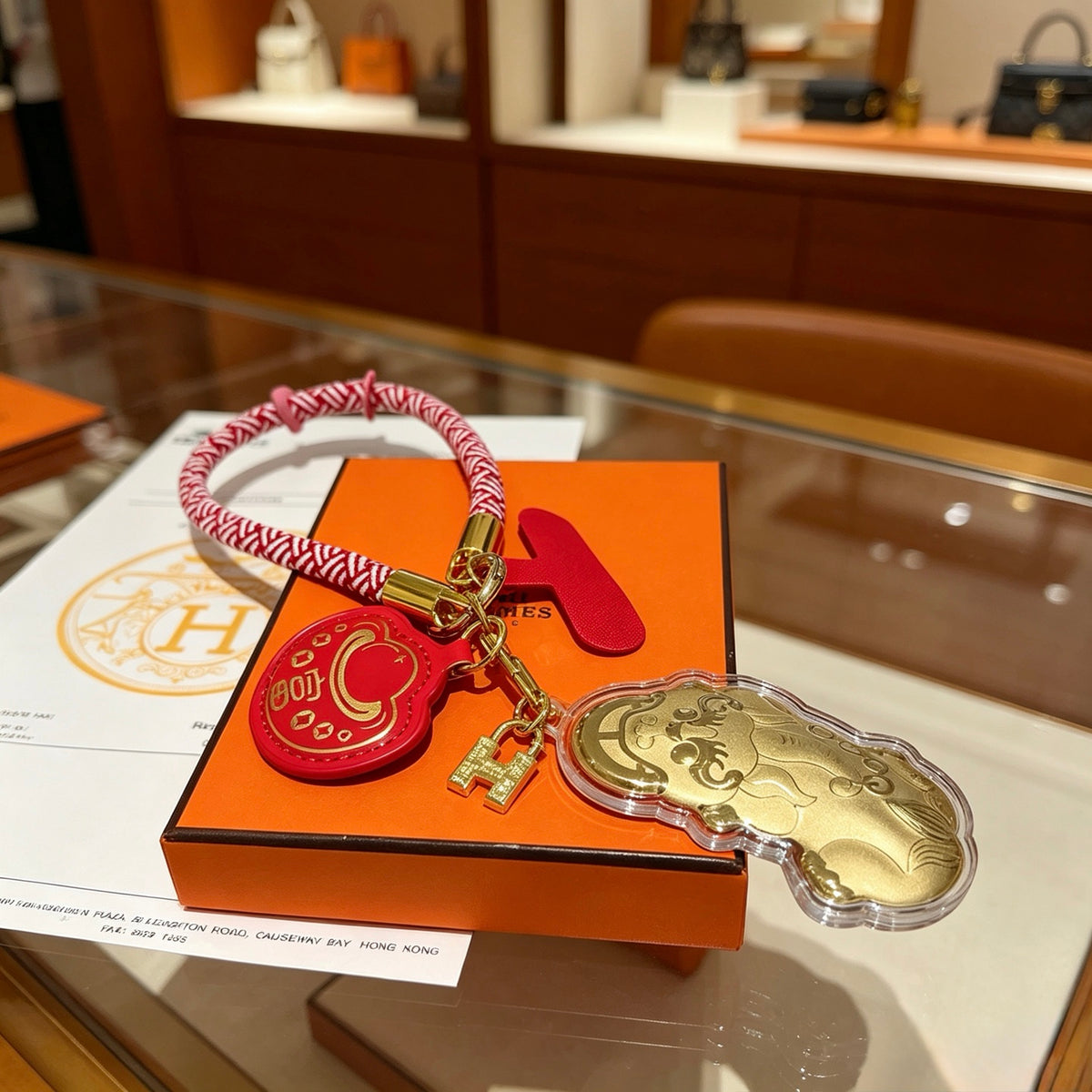 Hermès Gold-Tone Horse and Red H Disc Keychain with Pink Braided Cord - album image 2