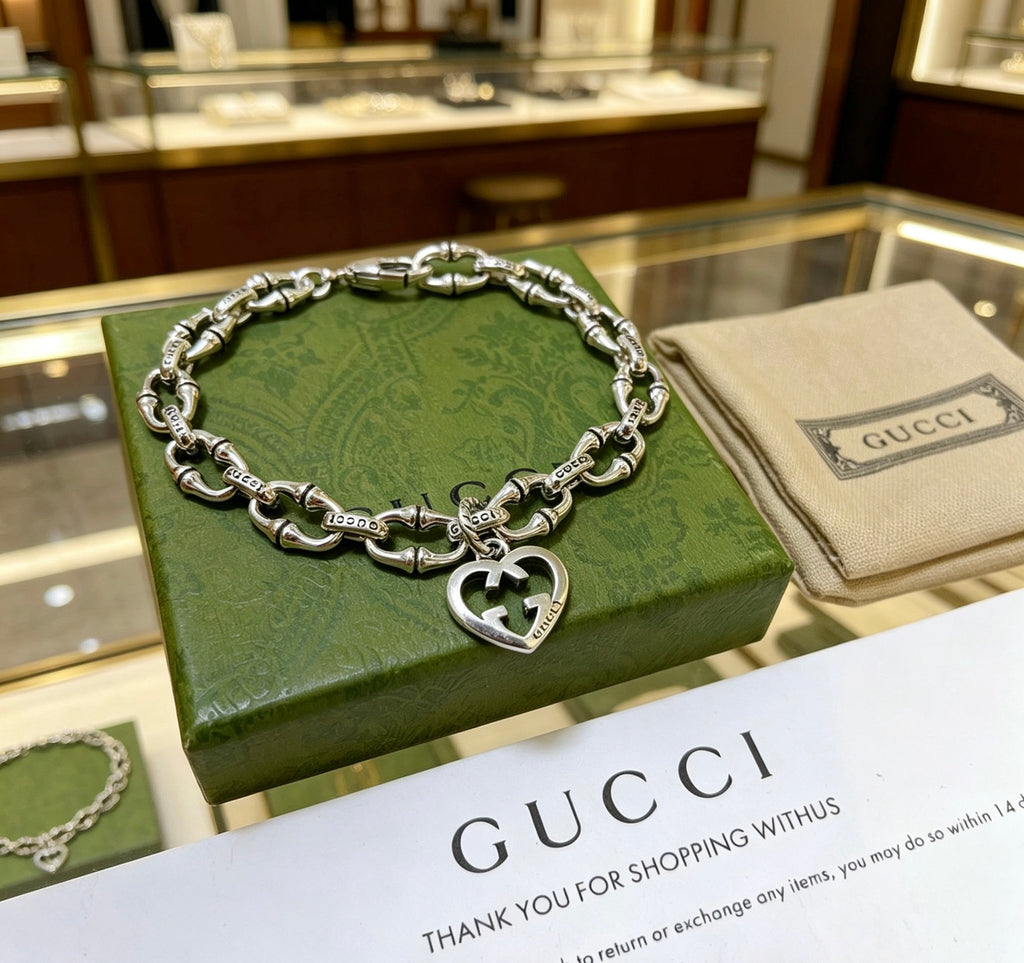 Gucci Silver-Tone Openwork Oval Link Bracelet with G Charm - album image 1