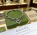 Gucci Silver-Tone Openwork Oval Link Bracelet with G Charm - album image 1