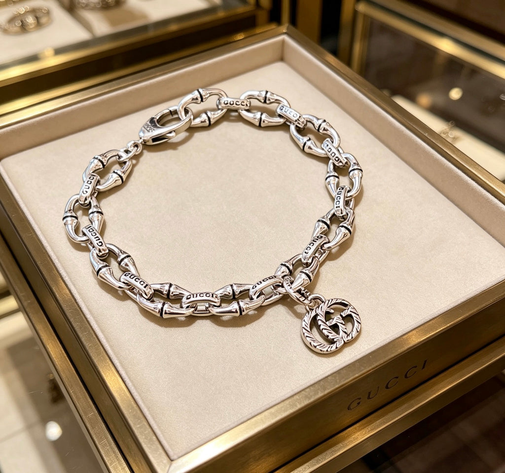 Gucci Silver-Tone Oval Link Bracelet with G Charm - album image 1