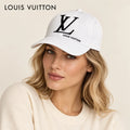 Model wearing louis vuitton embroidered baseball cap on head