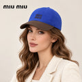 Woman wearing miu miu baseball cap on head