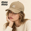 Model wearing miu miu hat on head